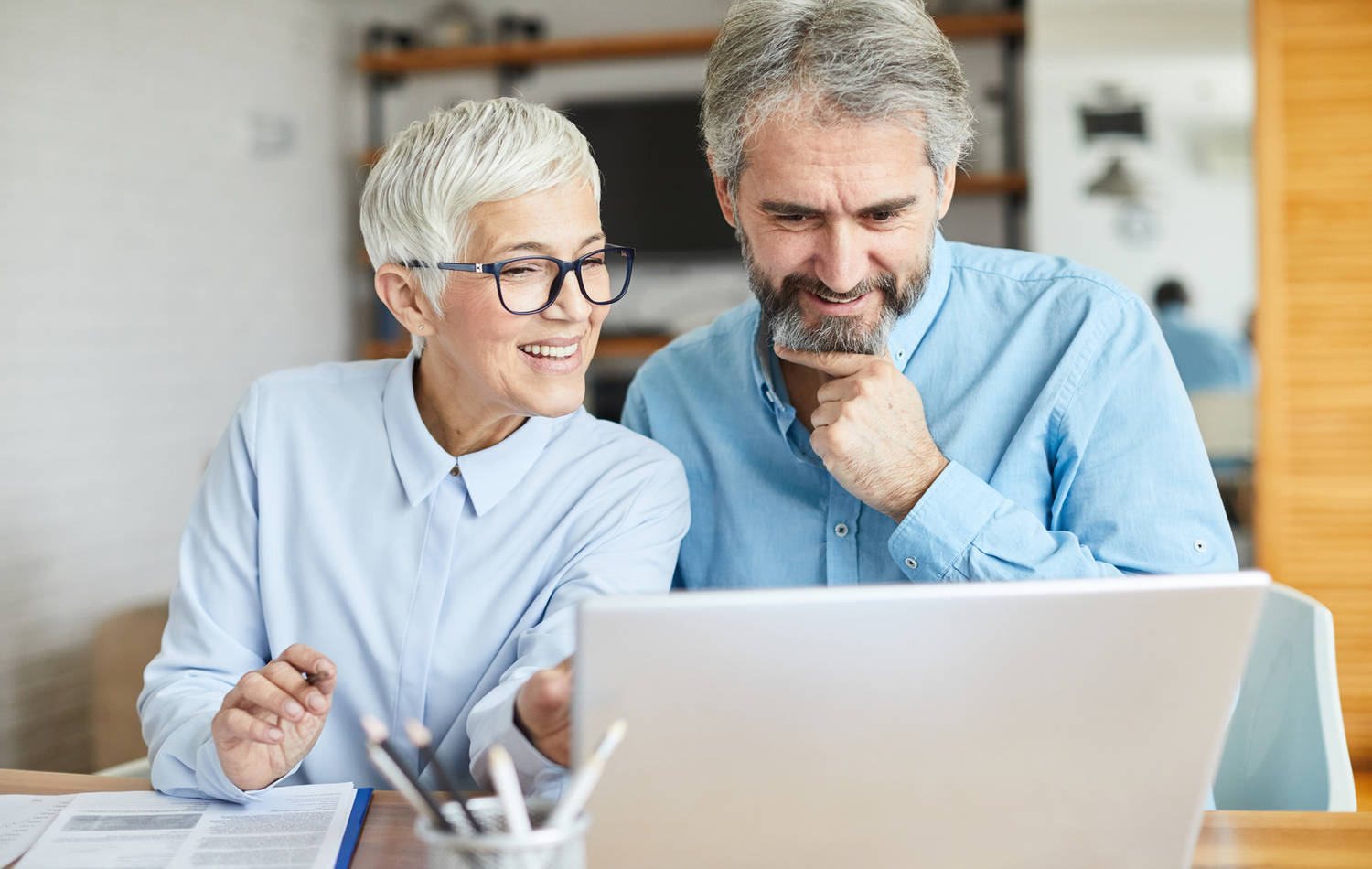 A couple happily using their computer together